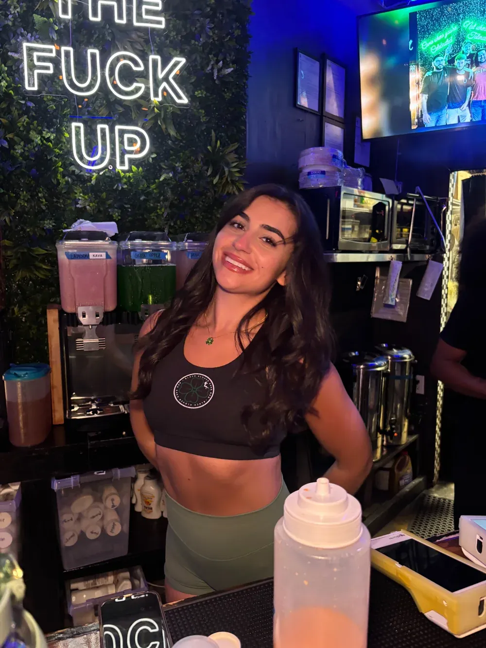 Alex smiling behind the Black Klover bar