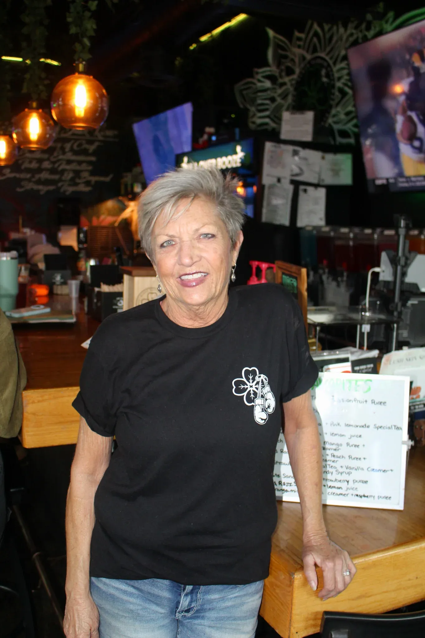Chrissy smiling beside the bar at Black Klover