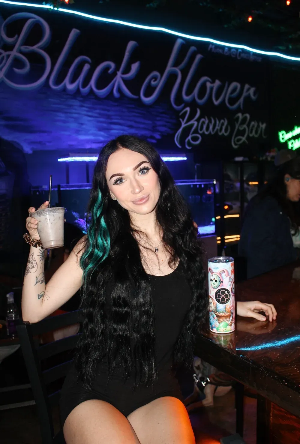 Luna holding a drink inside Black Klover