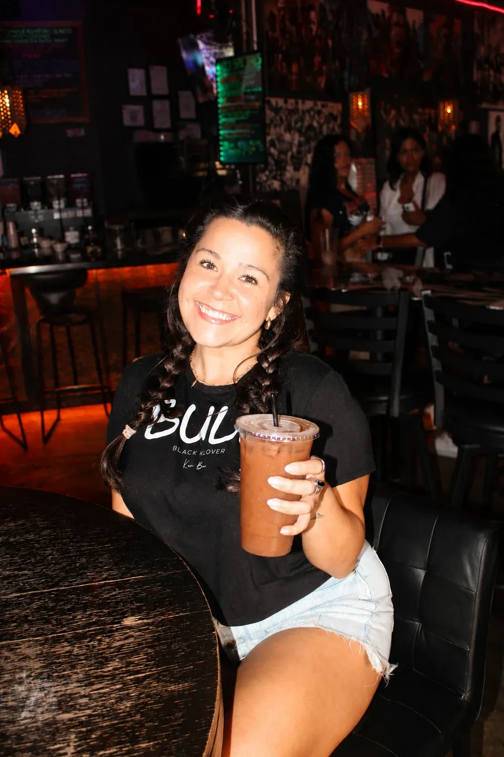 Shayla holding a drink inside Black Klover