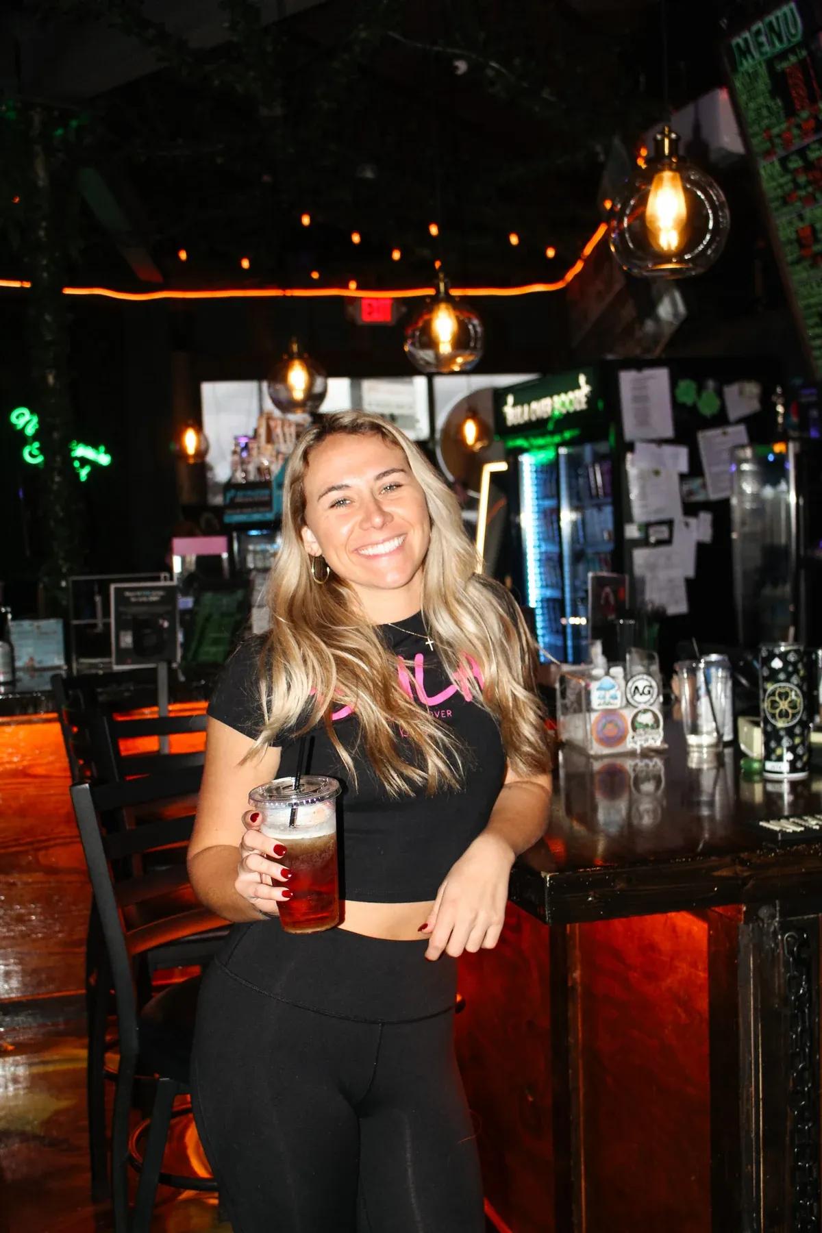 Victoria holding a drink inside Black Klover